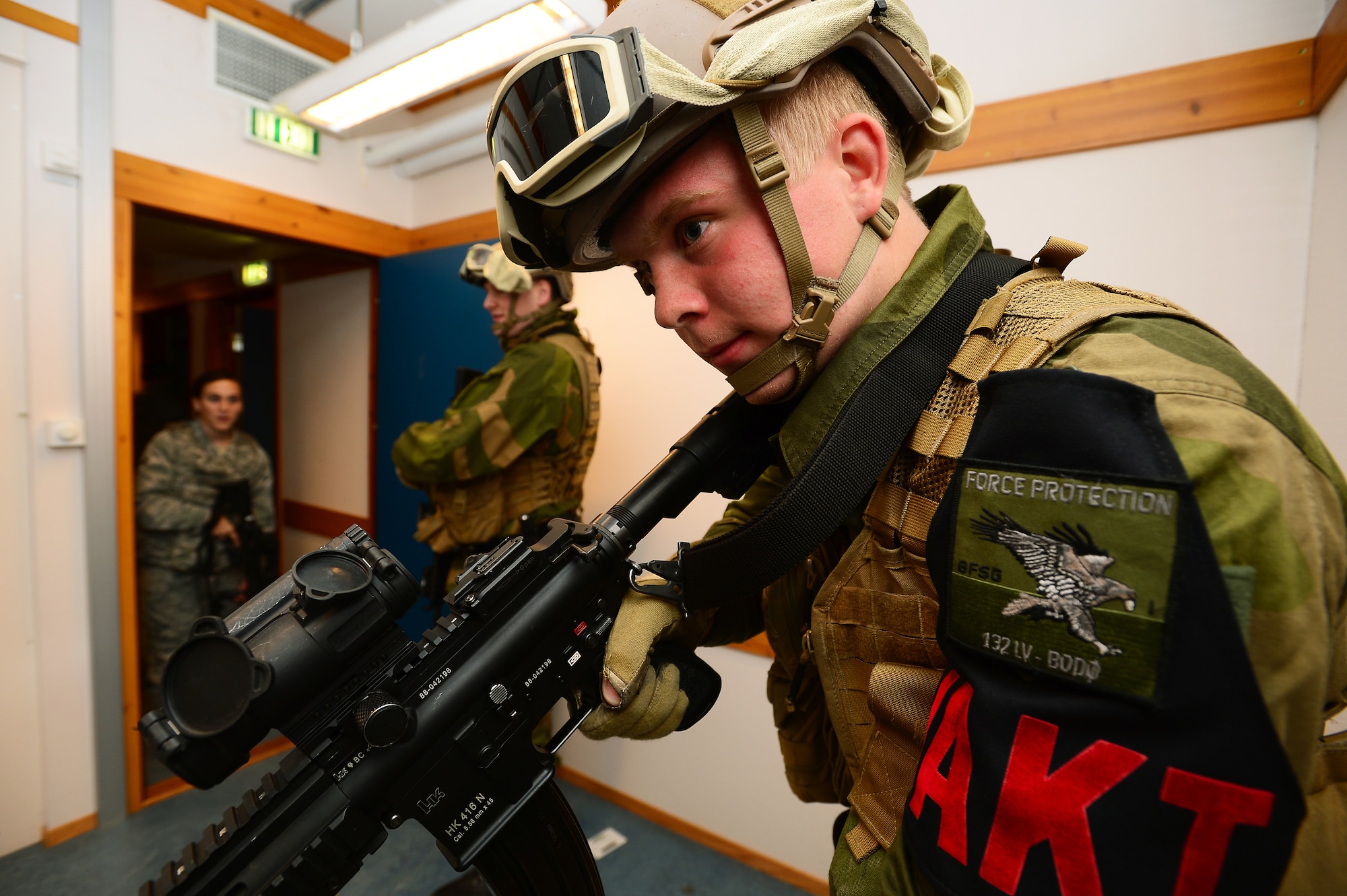 Royal Norwegian Air Force Pvt. Henrik Krefting moves into position during a close quarters combat exercise on Bodø Main Air Station Norway Sept. 26, 2013. Airmen from the 48th Security Forces Squadron teamed with the Norwegian Force Protection Office and Finnish Military Police to conduct the training on the final day of the Arctic Challenge Exercise 2013.  ACE-13 was a combined exercise with NATO and regional allies, which promoted continued interoperability between the U.S., Norway, Sweden, Finland the U.K. and NATO. (U.S. Air Force photo by Master Sgt. Lee Osberry/Released)