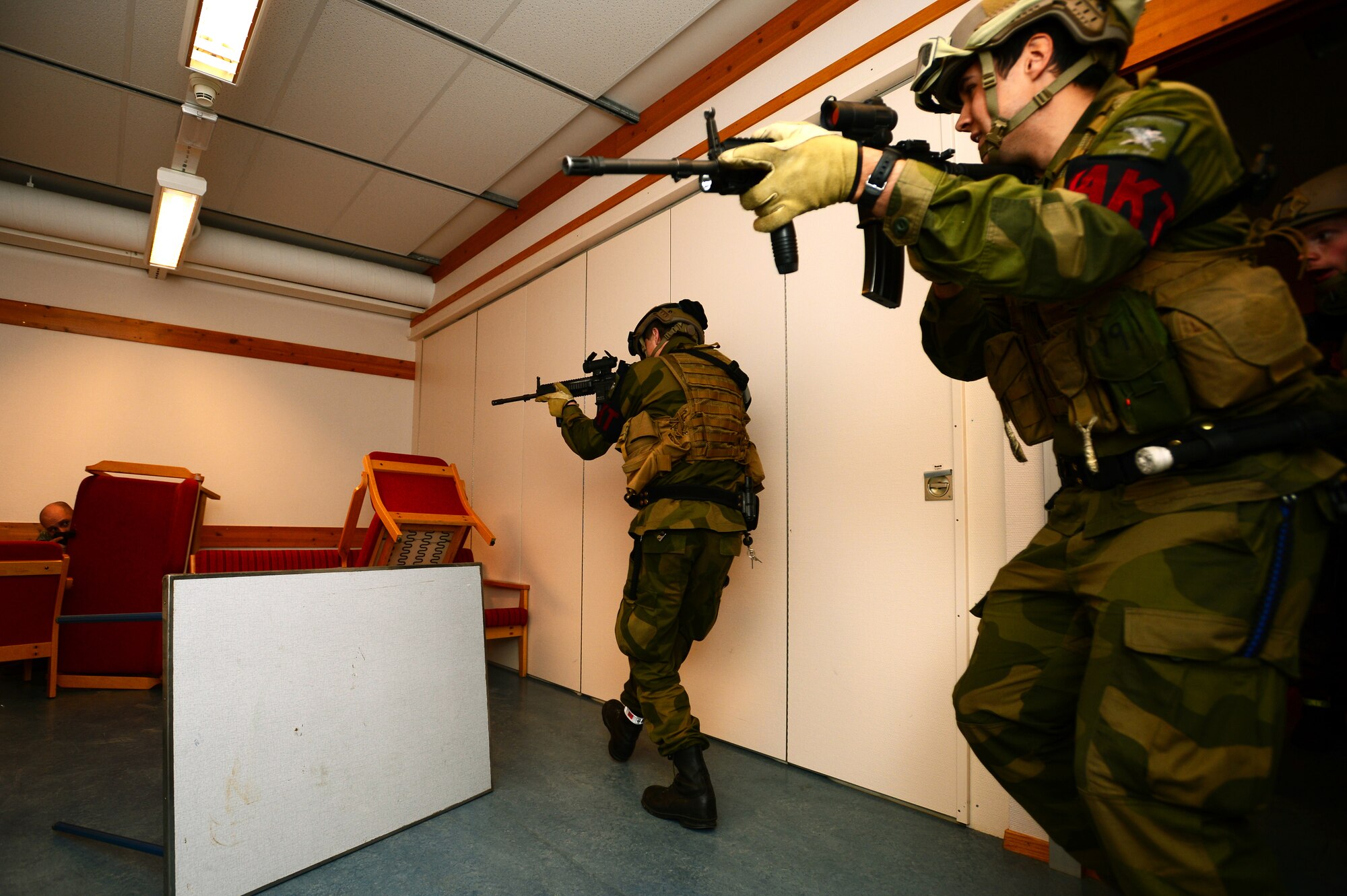 Royal Norwegian Air Force force protection members secure a barricaded assailant during a close quarters combat exercise on Bodø Main Air Station, Norway Sept. 26, 2013. Airmen from the 48th Security Forces Squadron teamed with the Norwegian Force Protection Office and Finnish Military Police to conduct the training on the final day of the Arctic Challenge Exercise 2013.  ACE-13 was a combined exercise with NATO and regional allies, which promoted continued interoperability between the U.S., Norway, Sweden, Finland the U.K. and NATO. (U.S. Air Force photo by Master Sgt. Lee Osberry/Released)