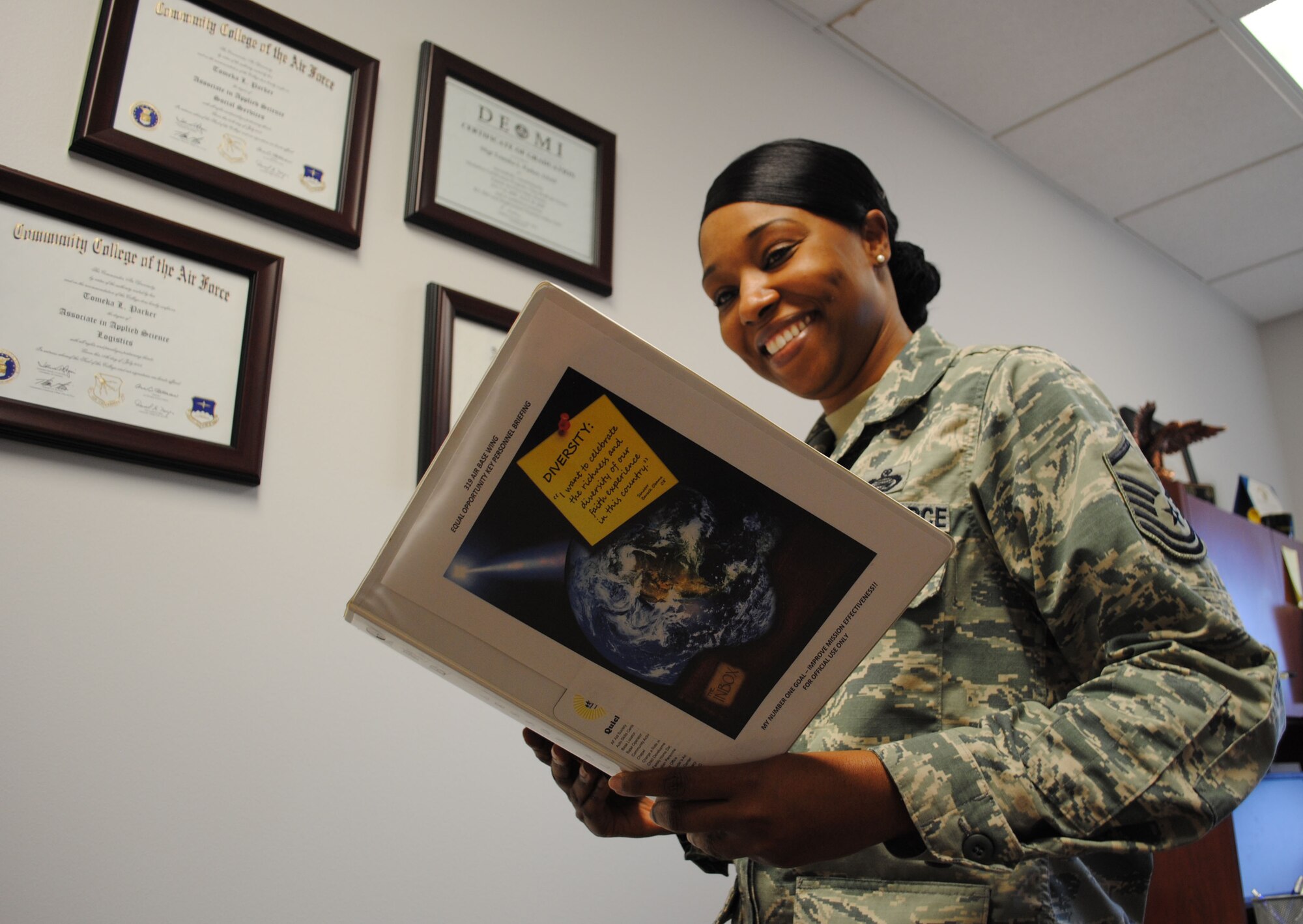 Master Sgt. Tomeka Parker, director of Equal Opportunity for the 319th Air Base Wing, reviews information prepared for a future EO briefing, Sept. 30, 2013, at Grand Forks Air Force Base, N.D.   The Lafayette, La.,-native is the base’s Warrior of the Week for the first week of October 2013. (U.S. Air Force photo/Staff Sgt. Luis Loza Gutierrez) 
