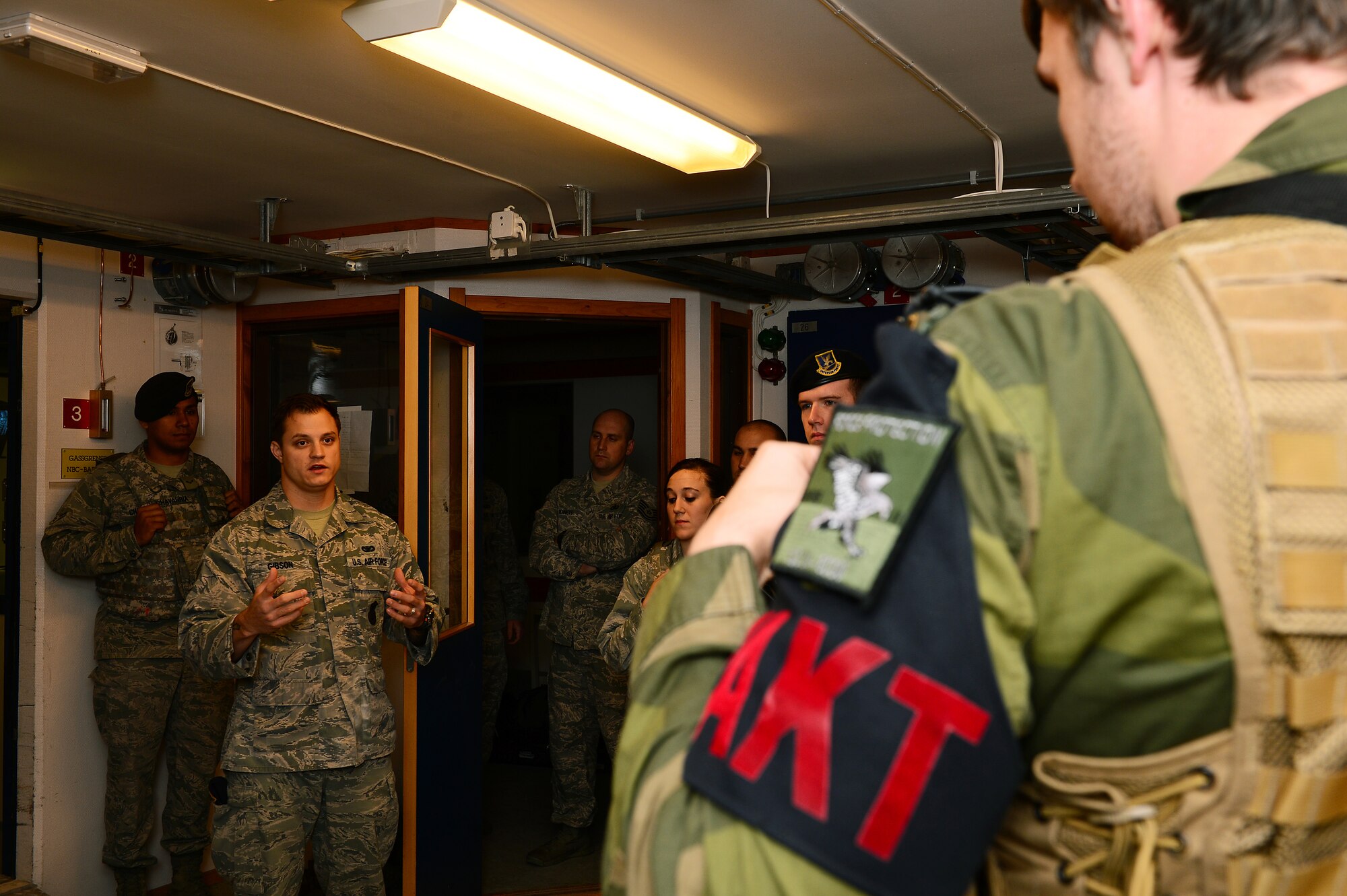 Staff Sgt. Raymond Gibson, 48th Security Forces Squadron base defense operations center controller, briefs participants on the ground rules during a close quarters combat exercise on Bodø Main Air Station, Norway Sept. 26, 2013. Airmen from the 48th SFS teamed with the Norwegian Force Protection Office and Finnish Military Police to conduct the training on the final day of the Arctic Challenge Exercise 2013.  ACE-13 was a combined exercise with NATO and regional allies, which promoted continued interoperability between the U.S., Norway, Sweden, Finland the U.K. and NATO. (U.S. Air Force photo by Master Sgt. Lee Osberry/Released)