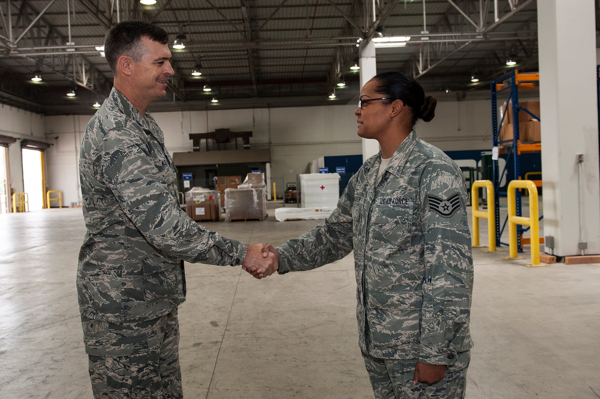 Staff Sgt. Elizabeth Klauser, 39th Logistics Readiness Squadron storage and issue supervisor, receives a coin from Col. Craig Wills, 39th Air Base Wing commander, Oct. 2, 2013, at Incirlik Air Base, Turkey.  "Pick of the 'Lik’" recognizes outstanding members of Team Incirlik who display a commitment to excellence. Airmen are nominated by their squadron supervision and selected by 39th Air Base Wing senior leadership for recognition. (U.S. Air Force photo by Airman 1st Class Nicole Sikorski/Released)

