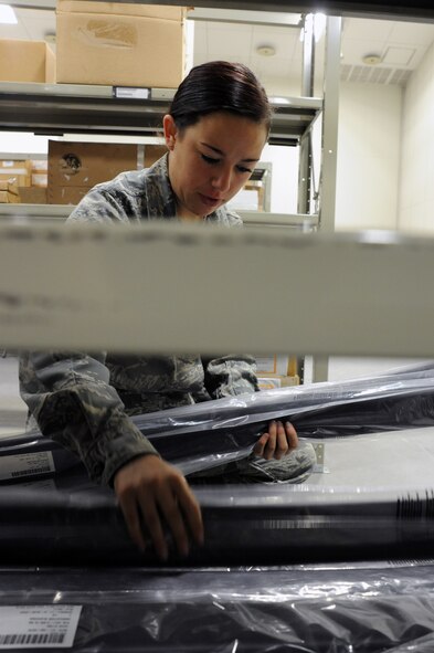 Airman Alexandria Thompson, 35th Logistics Readiness Squadron aircraft parts store apprentice, gathers equipment from the aircraft parts store at Misawa Air Base, Japan, Sept. 26, 2013. Ninety-five percent of the items held at the aircraft parts store are directly used for the 13th and 14th Fighter Squadrons at the base. (U.S. Air Force photo by Senior Airman Derek VanHorn)