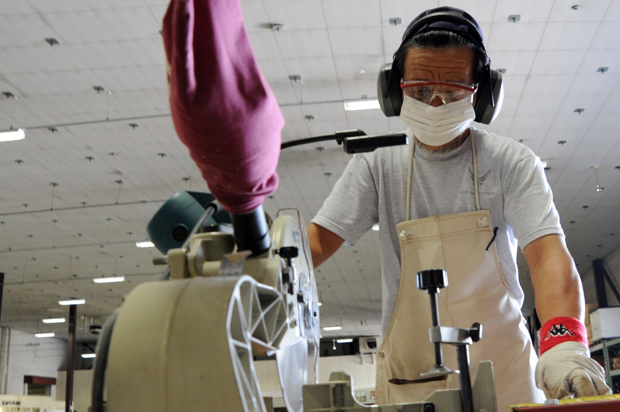 Masataka Nagoya, 35th Logistics Readiness Squadron traffic management section, cuts the frame for a shipping crate at the LRS supply warehouse at Misawa Air Base, Japan, Sept. 18, 2013. Twenty members of the cargo movement section process thousands of items to shops around base every week. (U.S. Air Force photo by Senior Airman Derek VanHorn)
