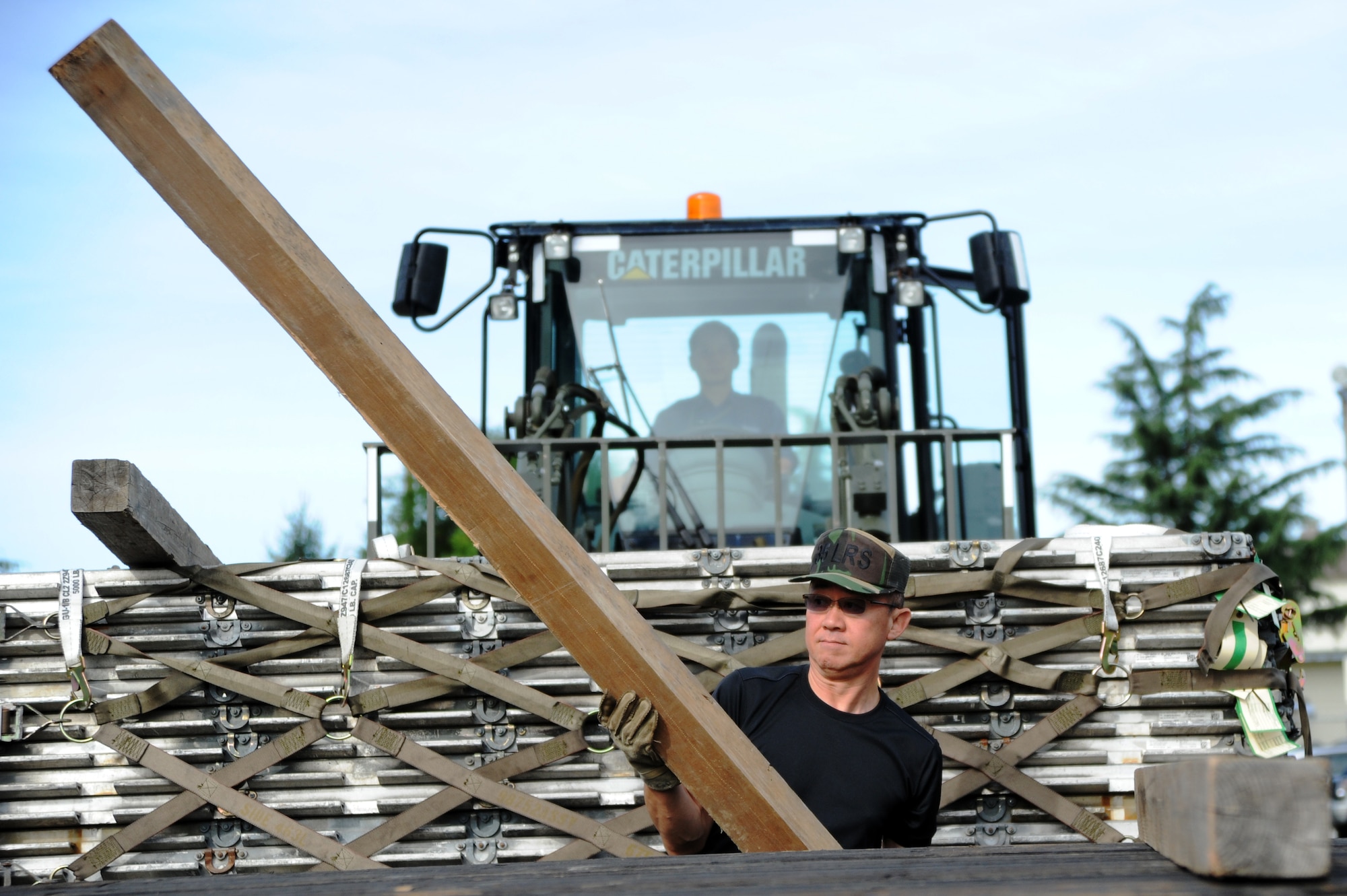Members of the 35th Logistics Readiness Squadron load cargo intended for the aircraft parts store at Misawa Air Base, Japan, Sept. 18, 2013. The LRS cargo supply section is responsible for processing around 100,000 items annually. (U.S. Air Force photo by Senior Airman Derek VanHorn)