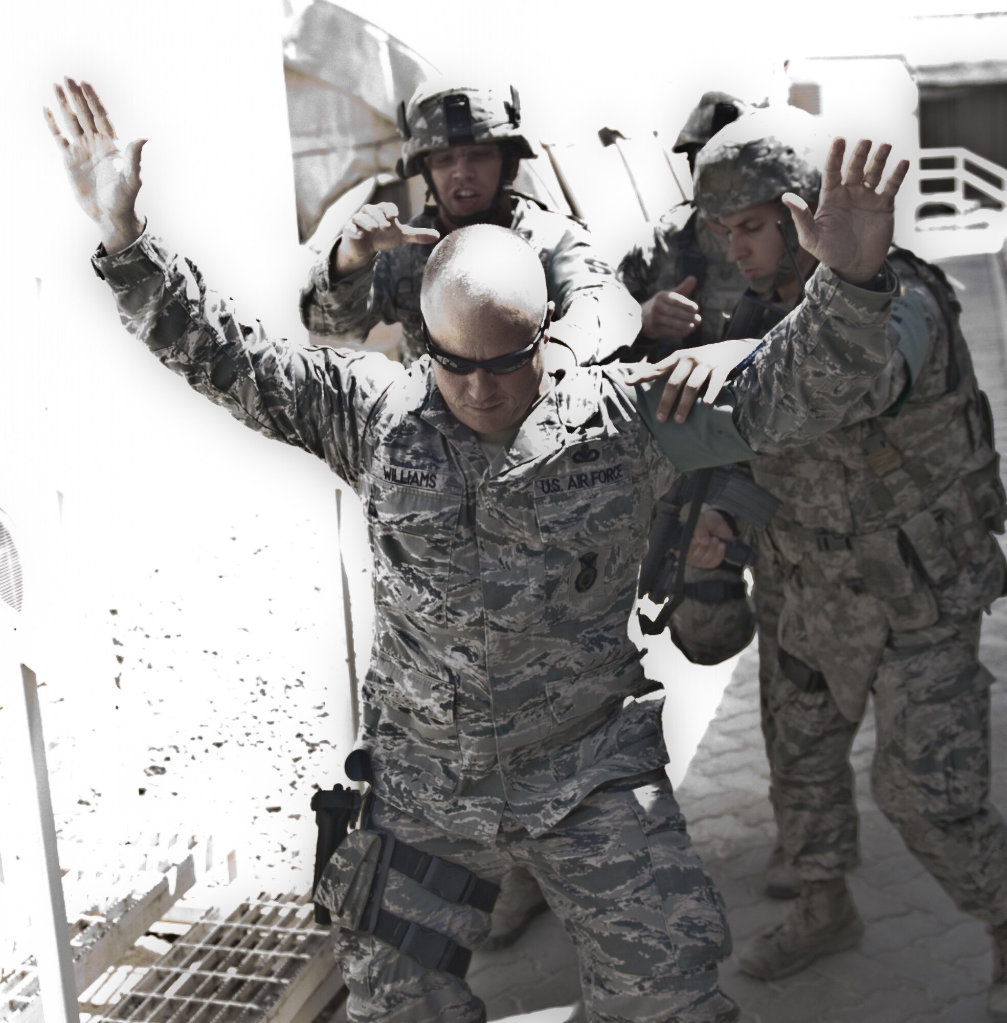 U.S. Air Force Master Sgt. Kyle Williams, 380th Expeditionary Security Forces Squadron logistics superintendant and exercise active-shooter, is taken down by security forces members ending an active-shooter exercise at an undisclosed location in Southwest Asia Sept. 26, 2013. Williams came out of the building peacefully after speaking with an Air Force Office of Special Investigations agent. Williams calls Lehighton, Penn., home. (U.S. Air Force photo illustration by Staff Sgt. Jacob Morgan)