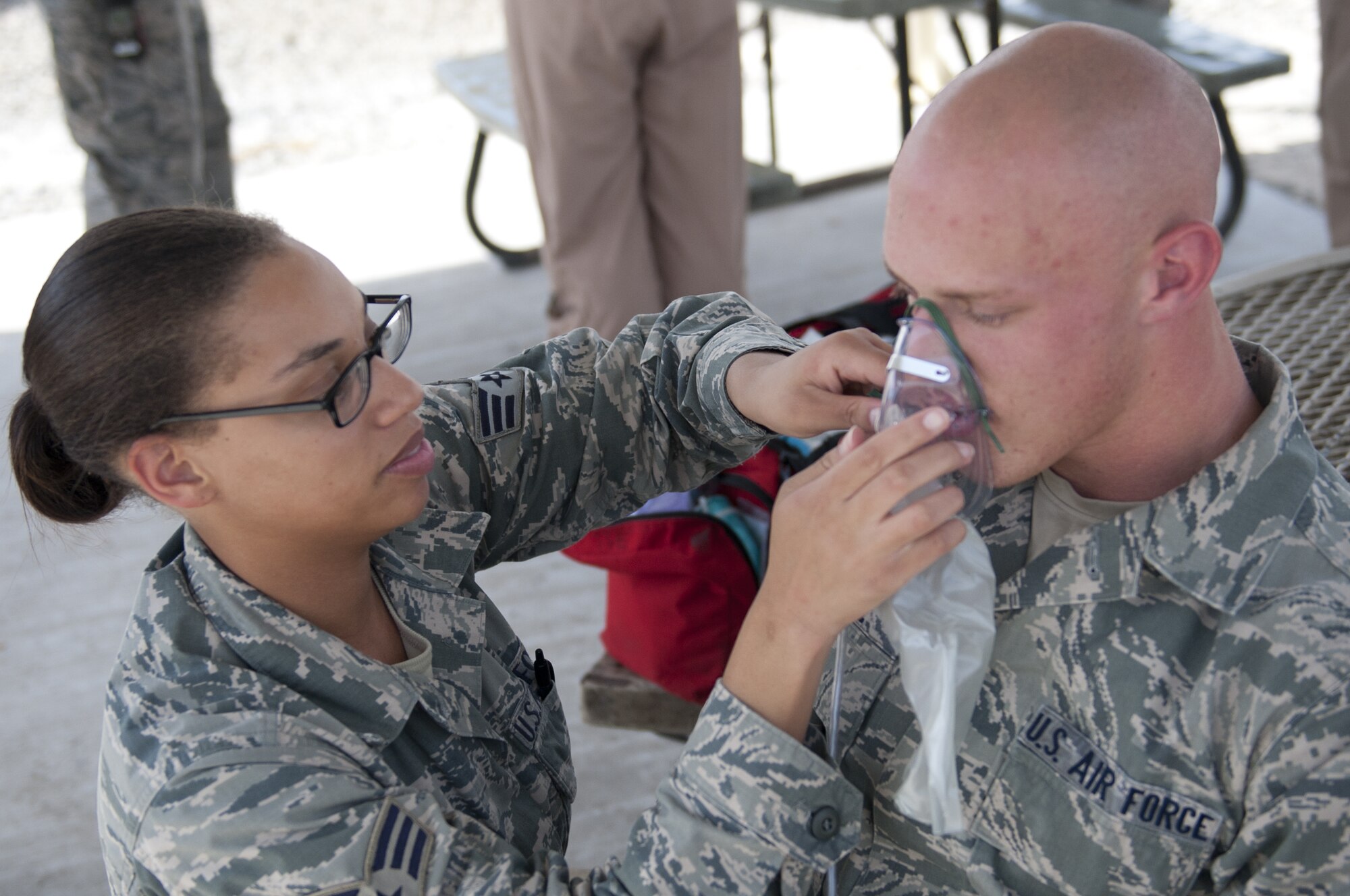 U.S. Air Force Senior Airman Keyeria Howard, 380th Expeditionary Medical Group medical technician, renders medical care to exercise victim U.S. Air Force Senior Airman Bo Hume during an active-shooter exercise at an undisclosed location in Southwest Asia Sept. 26, 2013. During the exercise, base personnel were on lockdown, security forces escorted medical personnel to the victims. Howard calls San Antonio, Texas, home and is deployed from Nellis Air Force Base, Nev. Hume calls Leominster, Mass., home and is deployed from Hurlburt Field, Fla. (U.S. Air Force photo by Staff Sgt. Jacob Morgan) 