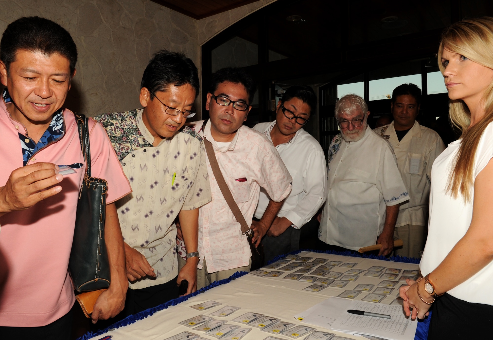 An honorary commander receives a name tag during an Honorary Commanders social event at the Kadena Marina seaside restaurant, Okinawa, Japan, Oct. 1, 2013. Approximately 90 guests were invited to this event to build a better relationship with the U.S. military and meet and greet new U.S. commanders. (U.S. Air Force photo by Naoto Anazawa)