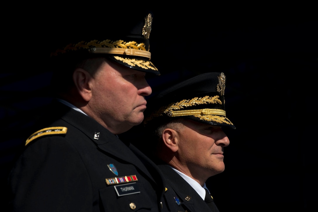U.S. Army Gen. James D. Thurman, outgoing commanding general of U.S. Forces Korea, stands with U.S. Army Gen. Curtis M. Scaparrotti, the incoming commanding general, at a change-of-command ceremony in Seoul, South Korea, Oct. 2, 2013.