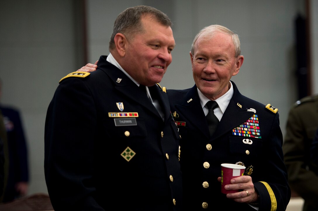 U.S. Army Gen. Martin E. Dempsey, right, chairman of the Joint Chiefs of Staff, talks with U.S. Army Gen. James D. Thurman, outgoing commanding general of U.S. Forces Korea, during a meeting with South Korean leaders in Seoul, South Korea, Oct. 1, 2013. After the meeting, Thurman relinquished command to U.S. Army Gen. Curtis M. Scaparrotti during a change-of-command ceremony.