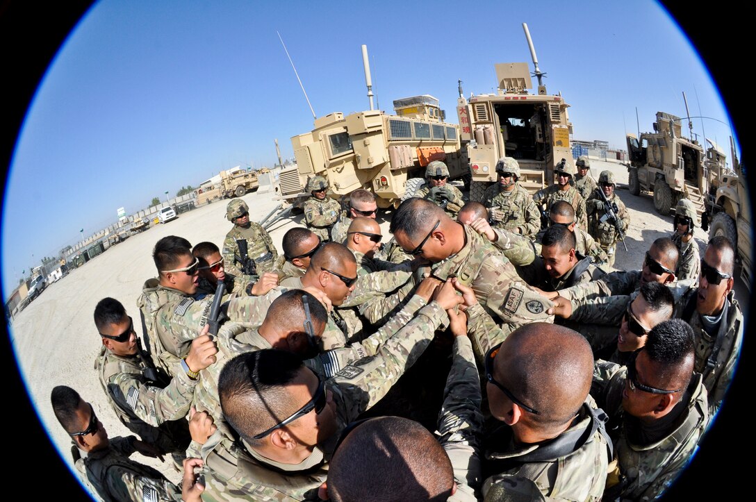 U.S. Army 1st Sgt. John C. Pangelinan, center, receives a pre-mission battle cry from his soldiers on Main Operating Base Lashkar Gah in Afghanistan's Helmand province in late September, 2013. Pangelinan is assigned to Company B, 1st Battalion, 294th Infantry Regiment, Guam Army National Guard.