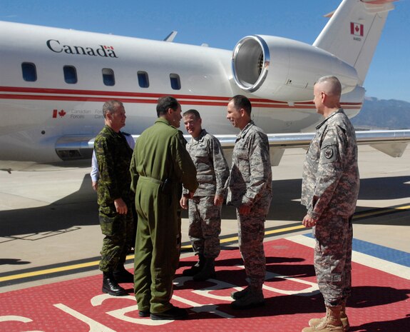 PETERSON AIR FORCE BASE, Colo.- The Canadian Chief of Defense Staff General Tom Lawson and the Canadian Forces Chief Warrant Officer, Chief Warrant Officer Kevin West are greeted by senior leaders for their visit to the North American Aerospace Defense Command (NORAD), Sept. 30, 3013. The purpose of the visit was to meet with NORAD Commander General Jacoby, Deputy Commander Lieutenant-General Parent and other senior leaders in order to gain additional insight into and appreciation of the Commands' unique missions, capabilities and advancement in the previous year and understand critical issues facing NORAD and USNORTHCOM in today's security environment. (U.S. Air Force by Senior Airman Kendra Alba/ Released)