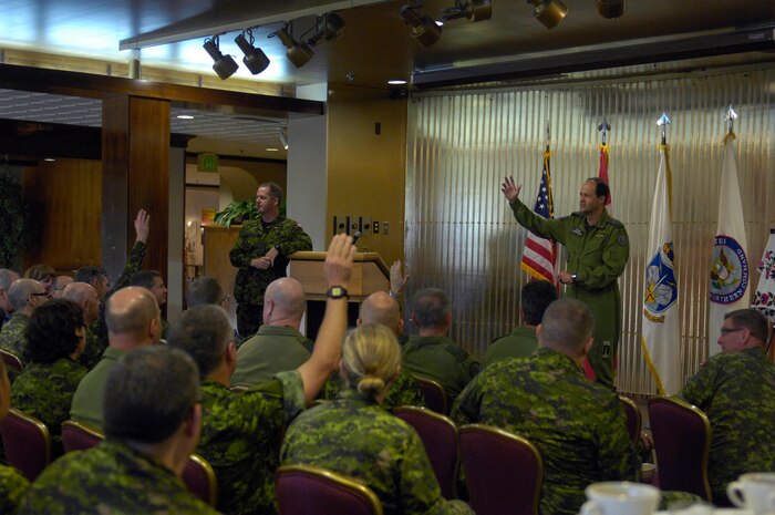 PETERSON AIR FORCE BASE, Colo.- The Canadian Chief of Defense Staff General Tom Lawson and the Canadian Forces Chief Warrant Officer, Chief Warrant Officer Kevin West speak with Canadian Armed Forces members working at the North American Aerospace Defense Command (NORAD) at an all-hands call on Oct. 1, 2013 at Peterson Air Force Base, Colo. The purpose of the visit was to meet with NORAD Commander General Jacoby, Deputy Commander Lieutenant-General Parent and other senior leaders in order to gain additional insight into and appreciation of the Commands' unique missions, capabilities and advancement in the previous year and understand critical issues facing NORAD and USNORTHCOM in today's security environment. (U.S. Air Force by Senior Airman Kendra Alba/ Released)