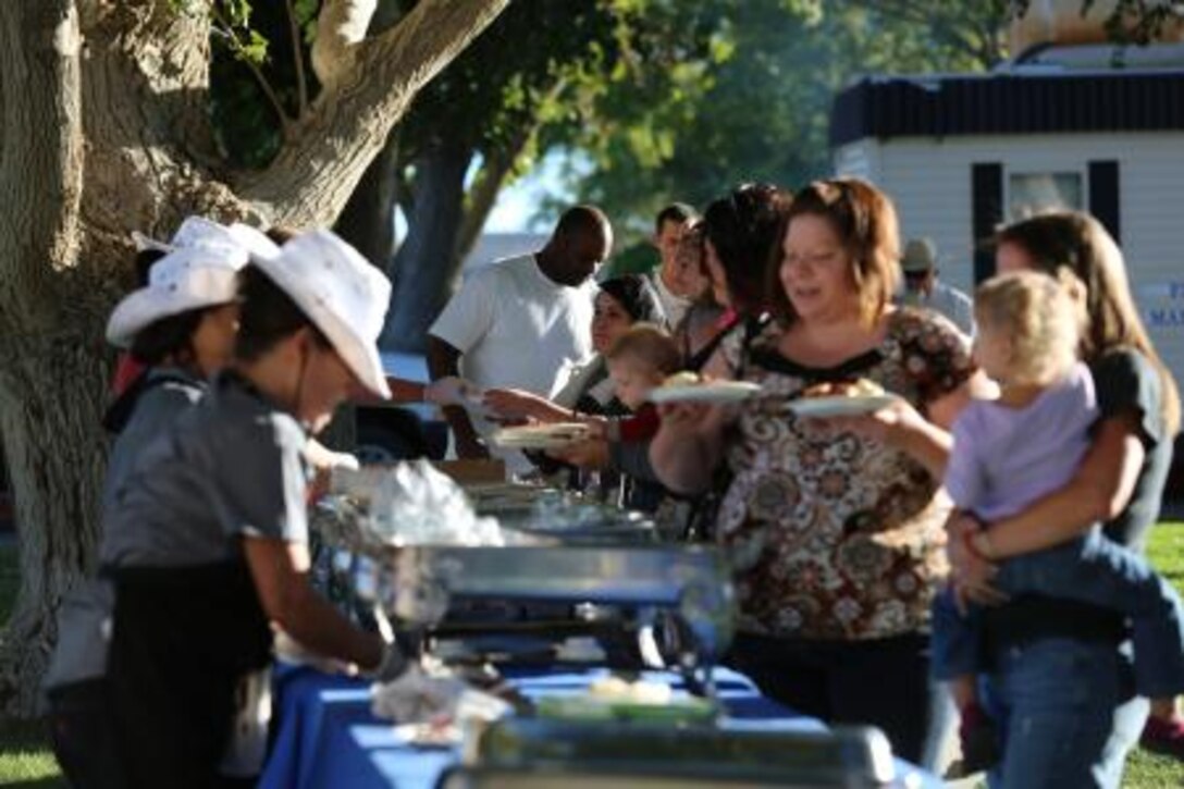 Families on Marine Corps Logistics Base Barstow, Calif., are served food during the MCLB Marine Corps Community Services 11th annual Fall Festival, Sept 26.


