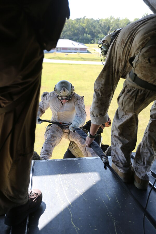 A Marine Multipurpose Canine (MPC) handler with Marine Corps Special Operations Command, and his dog fast rope off a MV-22 Osprey while conducting MPC Helicopter Rope Suspension Training Course aboard Camp Lejeune, N.C., Sept. 19, 2013. MARSOC MPC program is developing a standard operating procedures, while also partaking in the training to build the program.   (U.S. Marine Corps photo by Sgt. Anthony Carter/Released)