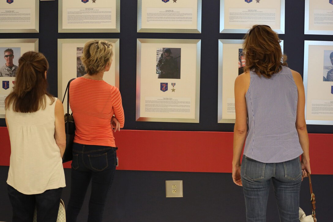Wives of commanders from North Carolina, observe the Hall of Honor at U.S. Marine Corps Forces, Special Operations Command Headquarters on Camp Lejeune, Sept. 13, 2013. The wives participated in a special operations forces symposium to get a glimpse at the capabilities MARSOC Marines bring to the fight. Major Gen. Mark Clark, commanding general, MARSOC, gave a brief on MARSOC's capabilities before the wives received and participated in a demonstration. (U.S. Marine Corps photo by Cpl. Samuel McKenzie/Released)  