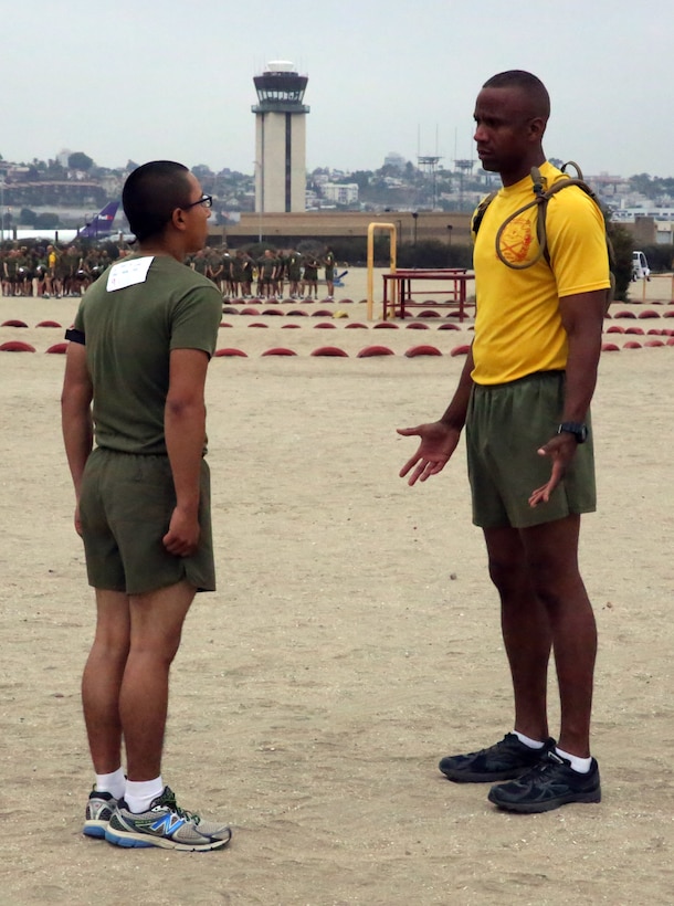 Gunnery Sgt. Carlos Campbell, senior drill instructor, Platoon 2149, Company G, 2nd Recruit Training Battalion, gives words of encouragement to Recruit Omar C. Duarte during the Physical Fitness Test aboard the depot Sept.19. Campbell mentors young recruits and fellow Marines alike.