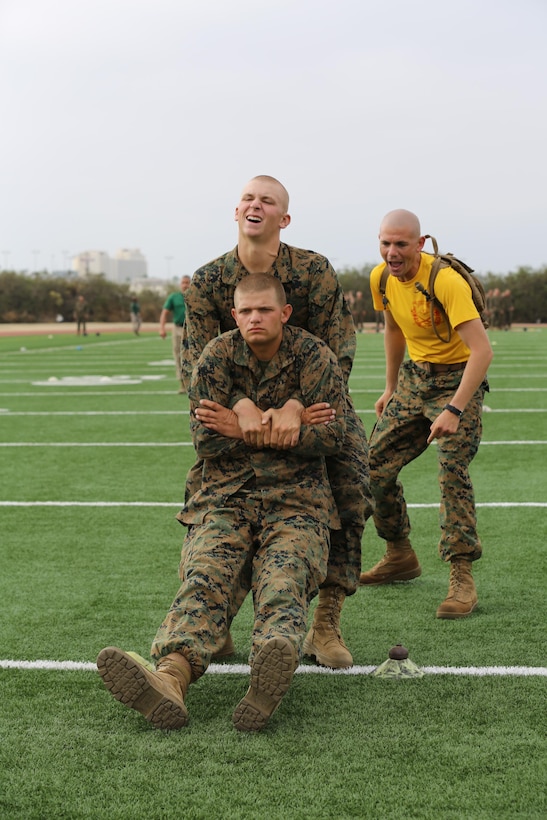 A Recruit of Company G, 2nd Recruit Training Battalion, performs a buddy drag during the Combat Fitness Test, for a final score aboard the depot, Sept. 12.  Recruits must buddy drag and fireman carry their partners through the Maneuver Under Fire course, which is 75-yards long.