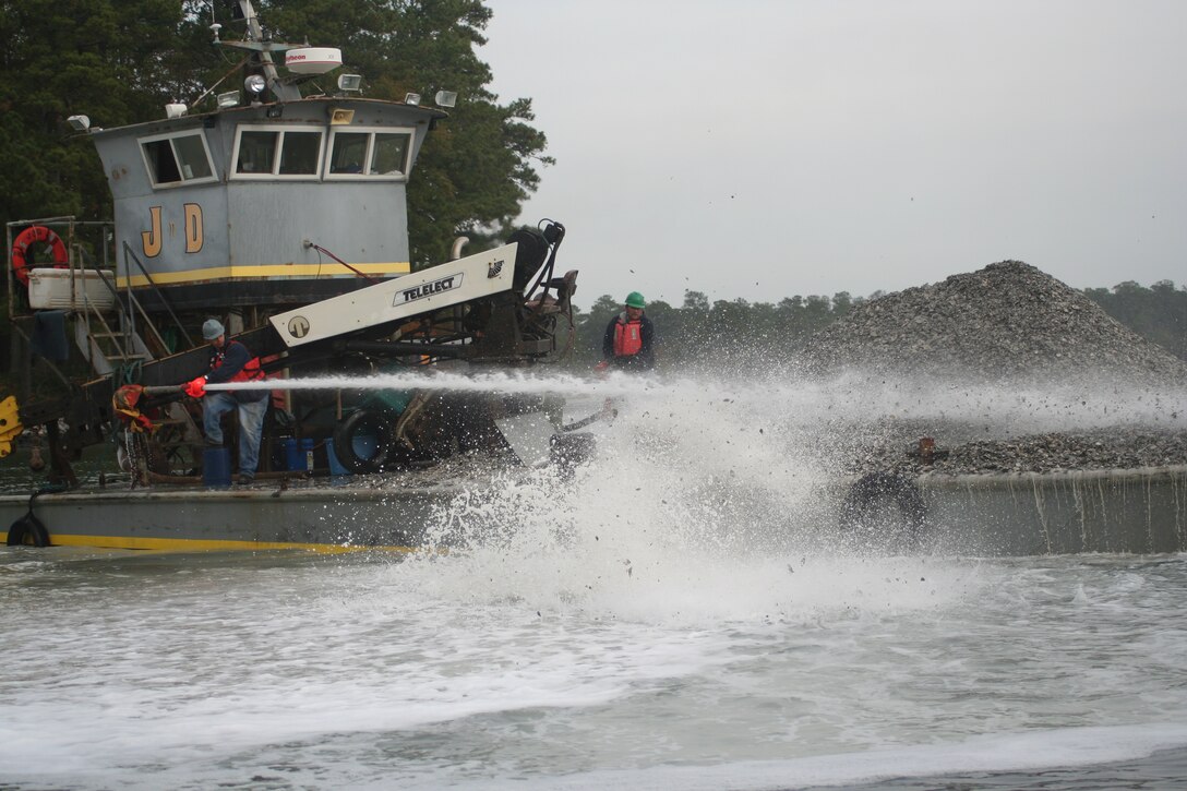 Baby oysters, or spat, are sprayed on a sanctuary reef.