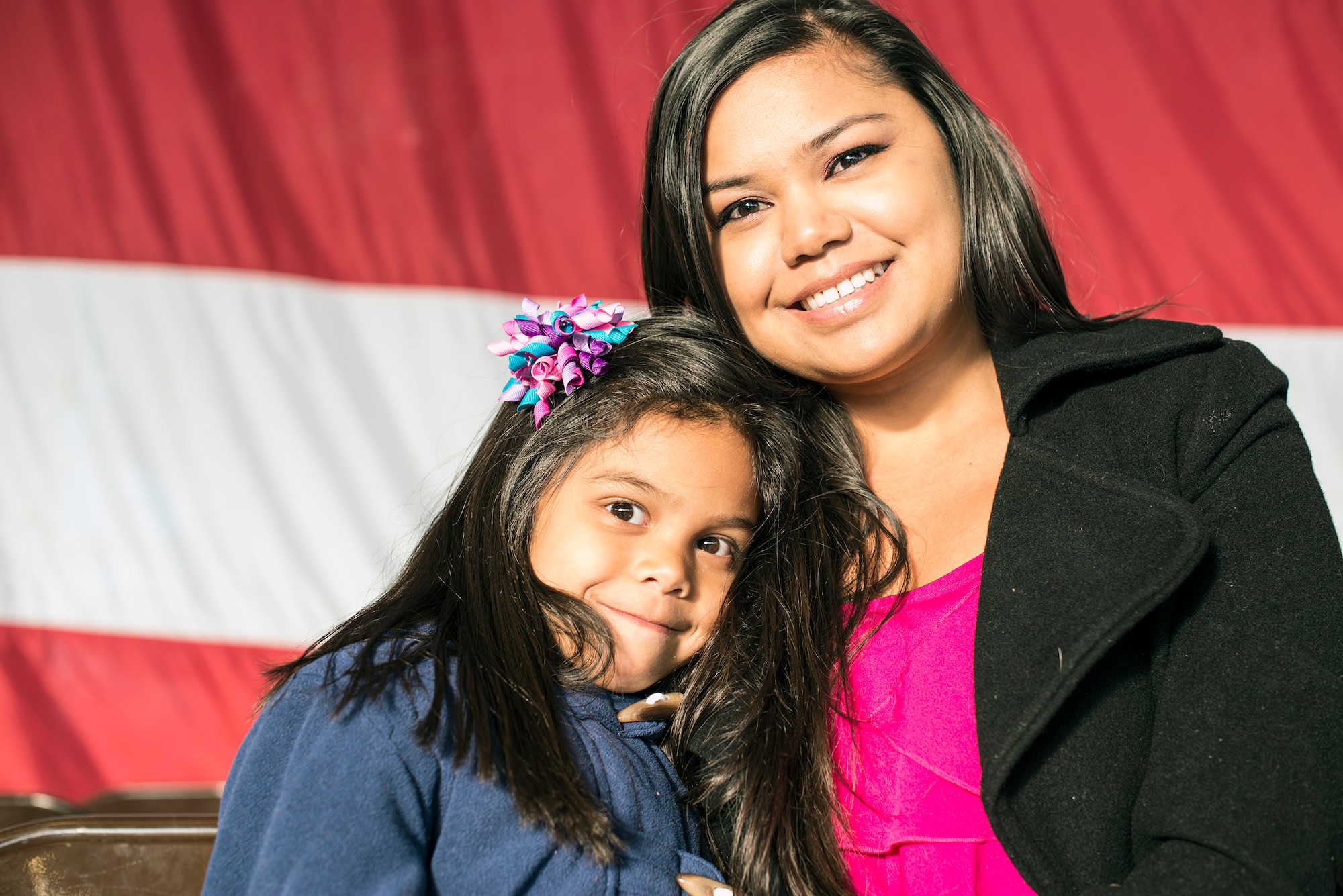 Six-year-old Aurea Paulino and her mom, Hillary, wait for Airman 1st Class Michael Paulino, a 366th Equipment Maintenance Squadron ammunition technician, to return from deployment at Mountain Home Air Force Base, Idaho, Oct. 3, 2013. Paulino was deployed to Southwest Asia. (U.S. Air Force photo by Master Sgt. Kevin Wallace/RELEASED)