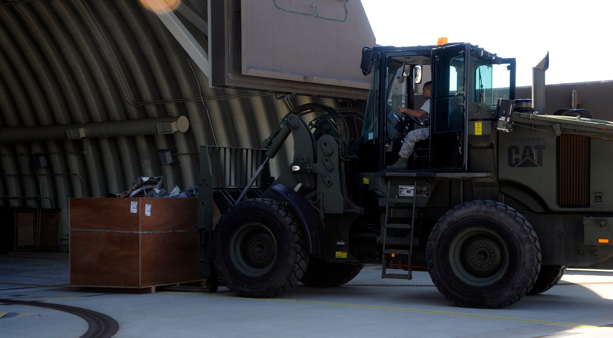 Airmen from the 8th Logistic Readiness Squadron pick up a pallet of cut up jet parts at Kunsan Air Base, Republic of Korea, Sept. 4, 2013. After months of preparation Airmen from the 8th LRS and 8th Maintenance Squadron helped ship the crashed F-16 Fighting Falcon on flatbed trucks bound for the U.S. (U.S. Air Force photo by Staff Sgt. Jessica Haas/ Released)