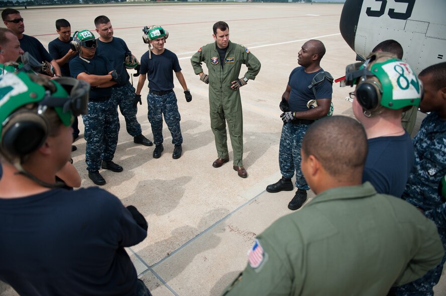 Aviation Structural Mechanic 3rd Class Alex Foncham, Fleet Logistics Support Squadron (VRC) 30, Detachment 5, gives a safety brief before preparing a C-2A Greyhound for takeoff at Kunsan Air Base, Republic of Korea, Oct. 1, 2013. The “Providers” delivered mail and cargo to the USS George Washington (CVN 73) off the coast of the Republic of Korea. (U.S. Air Force photo by Senior Airman Clayton Lenhardt/Released)