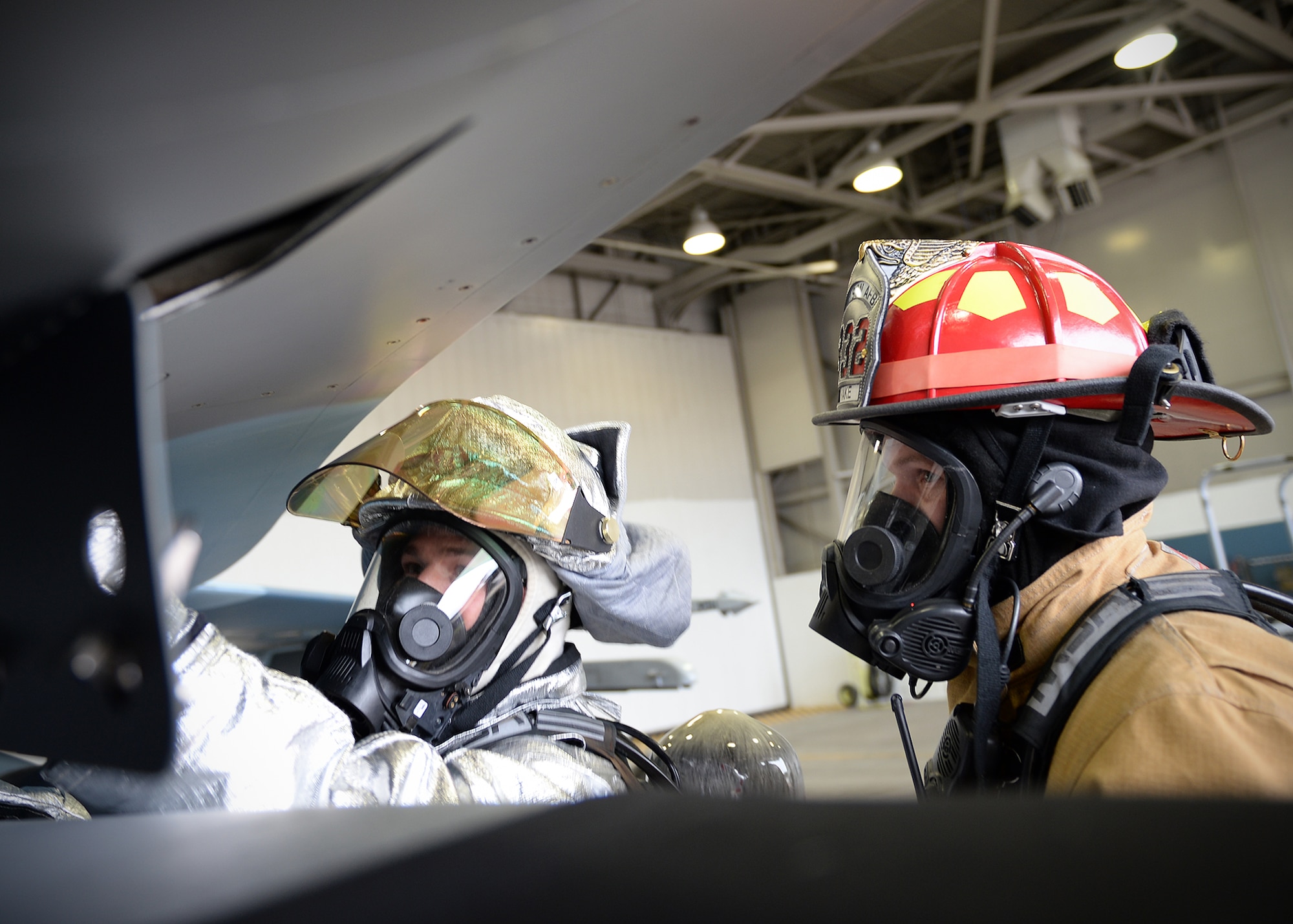 Staff Sgts. Alan Drake and Jerry Hann, 354th Civil Engineer Squadron lead firefighters, go through engine shut down procedures prior to entering the cockpit of an F-16 Fighting Falcon during training Sept. 19, 2013, Eielson Air Force Base, Alaska. Fire fighters train for different emergencies every day during their 24 hour shifts. (U.S. Air Force photo by Senior Airman Shawn Nickel/Released)