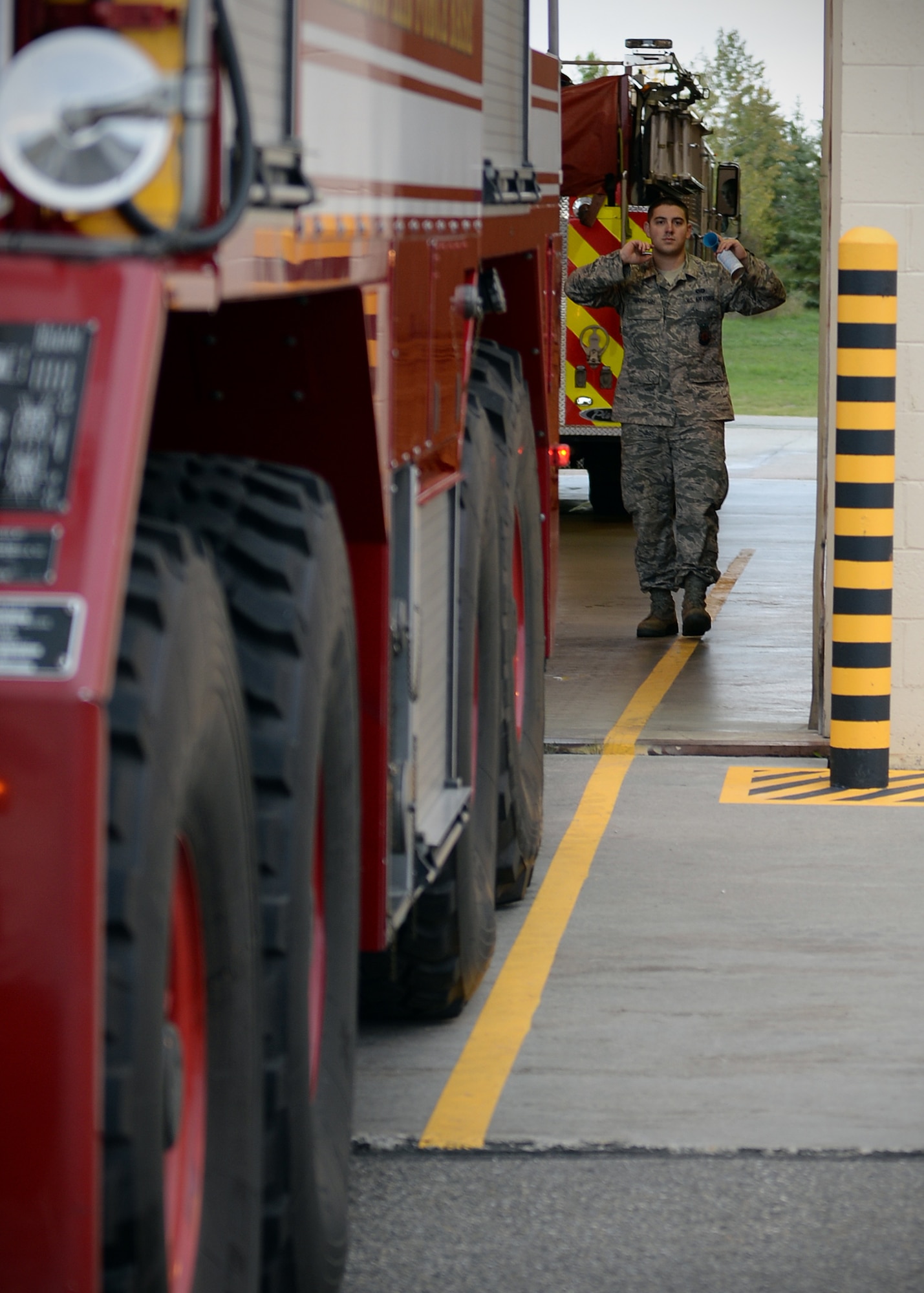 Airman 1st Class Kyle Larsen, 354th Civil Engineer Squadron firefighter, directs a fellow Airman who is backing a flight line fire engine into the bay of Fire Station One Sept. 19, 2013, Eielson Air Force Base, Alaska. Safety is the number one priority for all Airmen. (U.S. Air Force photo by Senior Airman Shawn Nickel/Released)
