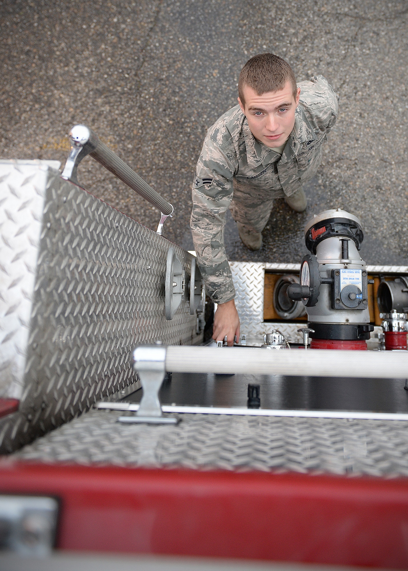 Airman 1st Class Matthew Kelly, 354th Civil Engineer Squadron firefighter, adjusts pressure to a tank on a fire engine Sept. 19, 2013, Eielson Air Force Base, Alaska. Airmen check all fluids and equipment at the beginning of every shift. (U.S. Air Force photo by Senior Airman Shawn Nickel/Released)