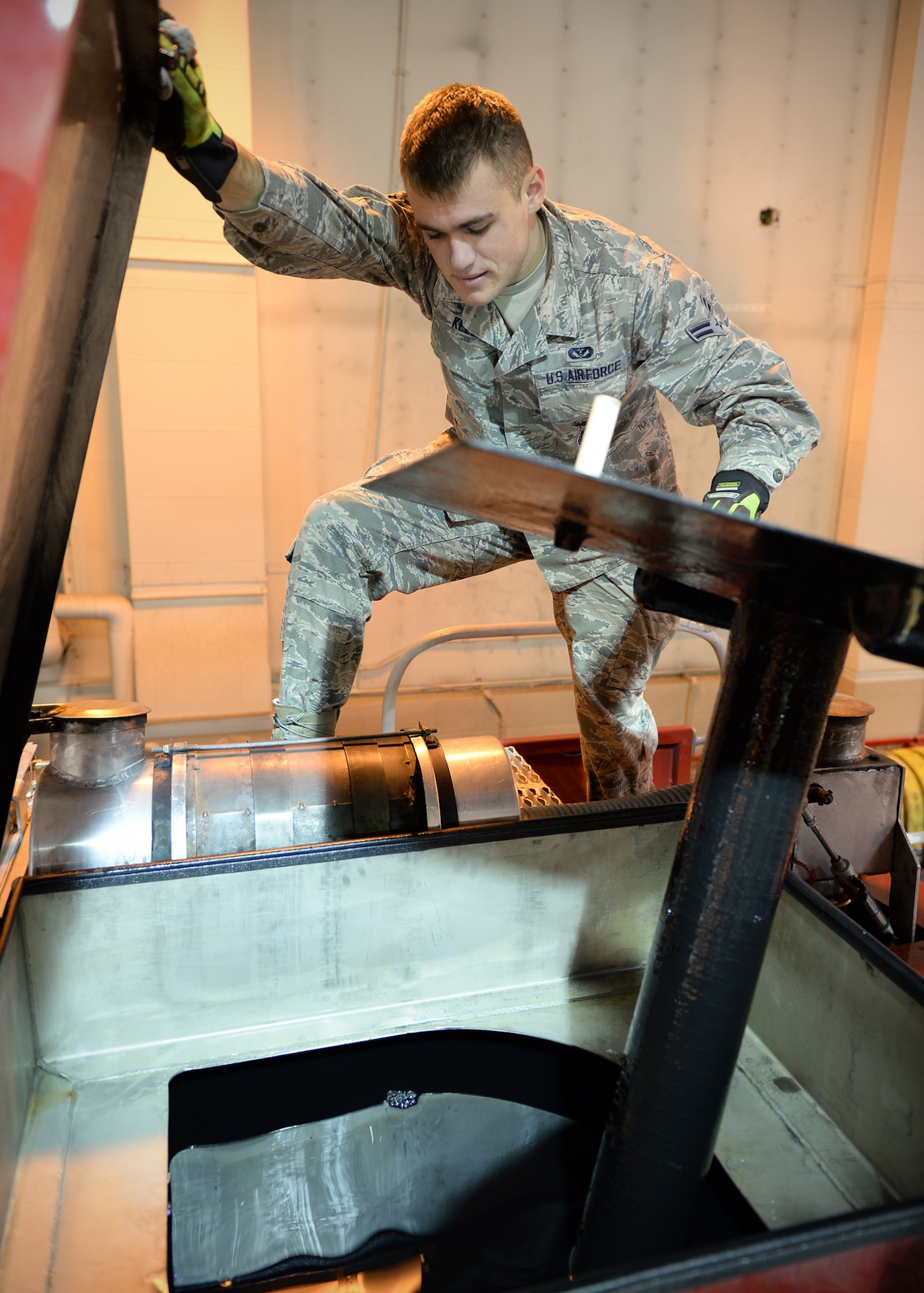 Airman 1st Class Matthew Kelly, 354th Civil Engineer Squadron firefighter, checks fire suppression liquids on an emergency vehicle Sept. 19, 2013, Eielson Air Force Base, Alaska. Airmen check all fluids and equipment at the beginning of every shift. (U.S. Air Force photo by Senior Airman Shawn Nickel/Released)