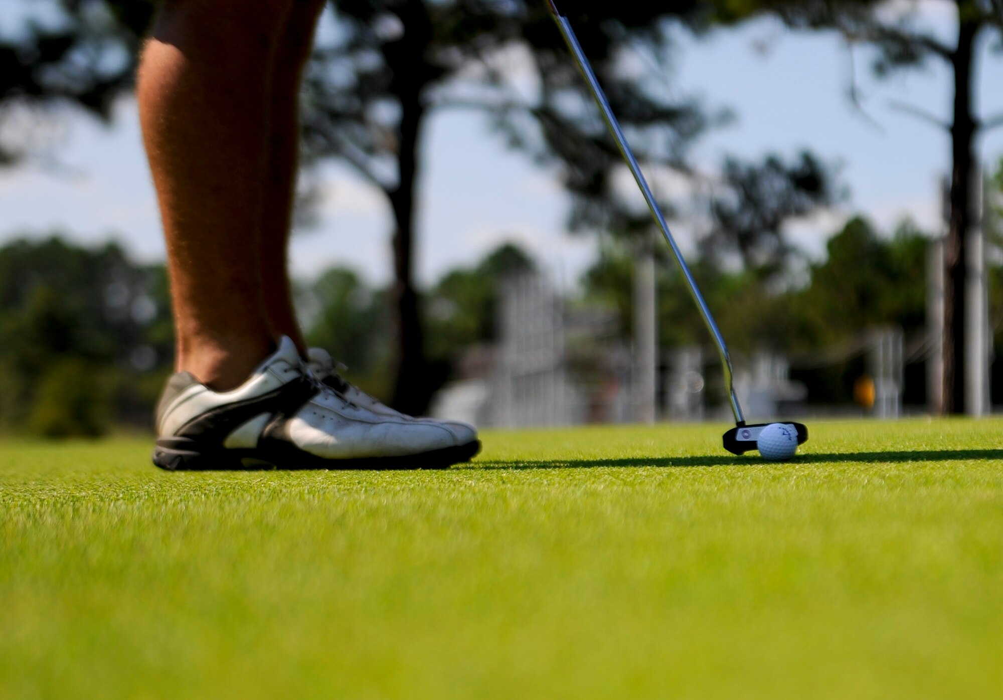 An Airman putts to finish a hole during the Free Golf Fun Day at Gator Lakes Golf Course on Hurlburt Field, Fla., Sept. 27, 2013. The Single Airman Program Initiative made it possible for 92 Airmen to golf at no cost. (U.S. Air Force photo/Airman 1st Class Jeff Parkinson)