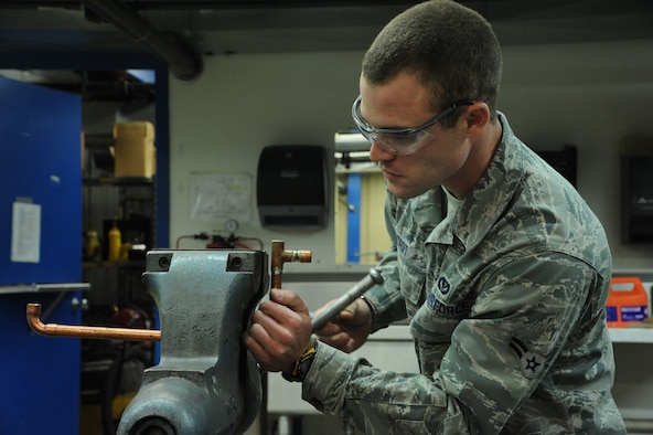 Airman 1st Class Matthew Yordt, 341st Civil Engineer Squadron heating ventilation and air conditioning technician, braces a piece of copper tubing in a table vice before brazing it with a torch. The 341st CES HVAC Airmen service more than 250 air conditioning units and 50 boilers that are installed in 156 Malmstrom facilities. (U.S. Air Force Photo/Airman 1st Class Collin Schmidt)  