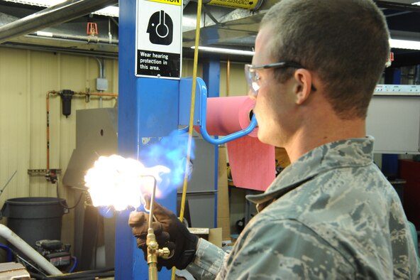 Airman 1st Class Matthew Yordt, 341st Civil Engineer Squadron heating ventilation and air conditioning technician, ignites a torch to solder copper tubing together. Airmen in the HVAC shop dedicate up to 200 man-hours per week on preventative maintenance of Malmstrom facilities. (U.S. Air Force Photo/Airman 1st Class Collin Schmidt)  