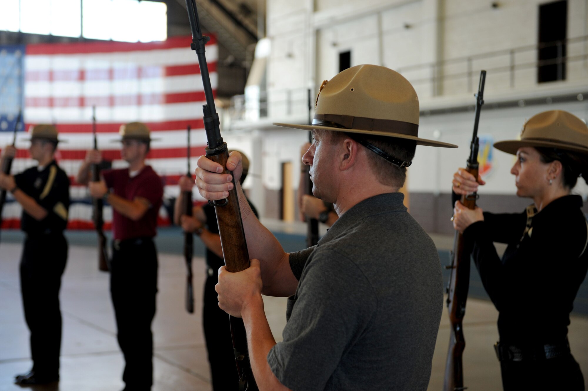 Matthew Jackson, Pennington County Deputy sheriff, executes rifle movements while practicing for a presentation of the colors in the Pride Hangar at Ellsworth Air Force Base, S.D. Sept. 30, 2013. The two day training will take place monthly, designed to refresh their memory and perfect the movements they learned during the initial course. (U.S. Air Force photo by Airman 1st Class Rebecca Imwalle/Released)