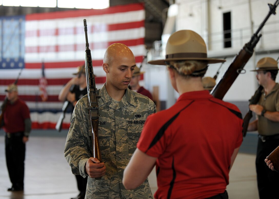 Senior Airman Bradley Sutter, 28th Logistics Readiness Squadron fuels distribution technician, conducts one-on-one rifle training with Natalie Morem, Pennington County correctional officer, in the Pride Hangar at Ellsworth Air Force Base, S.D. Sept. 30, 2013. The Pennington county sheriffs started their honor guard program April 2013 and chose to pattern it after the Air Force Honor Guard. (U.S. Air Force photo by Airman 1st Class Rebecca Imwalle/Released)