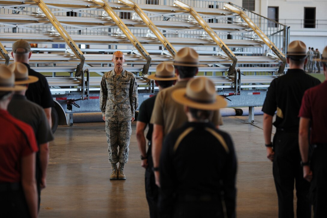 Senior Airman Bradley Sutter, 28th Logistics Readiness Squadron fuels distribution technician, calls movement commands in the Pride Hangar at Ellsworth Air Force Base, S.D. Sept. 30, 2013. Ellsworth Honor Guard provided a two day training course to help form the Pennington County Sheriff’s Department Honor Guard program. (U.S. Air Force photo by Airman 1st Class Rebecca Imwalle/Released)