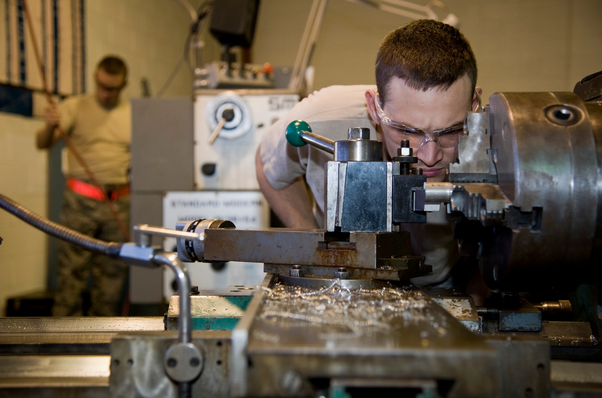 Airman 1st Class Travis W. Walker, 22nd Maintenance Squadron fabrication flight metals technician apprentice, fabricates a part of an attach barrier with a lathe machine Sept. 26, 2013, at McConnell Air Force Base, Kan. Metals technicians have a variety of machines to repair base equipment and create metallic objects from scratch. (US Air Force photo/Airman 1st Class John Linzmeier)