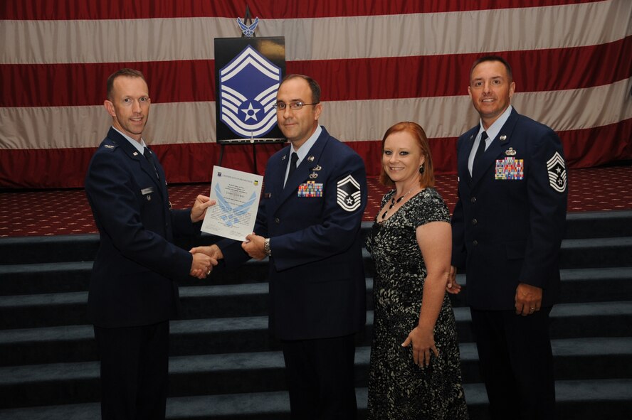 Senior Master Sgt. James Durio, 26th Operational Weather Squadron, receives a certificate of promotion from Col. Leland Bohannon, 2nd Bomb Wing vice commander, and Chief Master Sgt. Curtis Storms, 2nd Bomb Wing command chief, during the September Wing Promotion Ceremony on Barksdale Air Force Base, La., Sept. 30, 2013. (U.S. Air Force photo/Senior Airman Sean Martin)