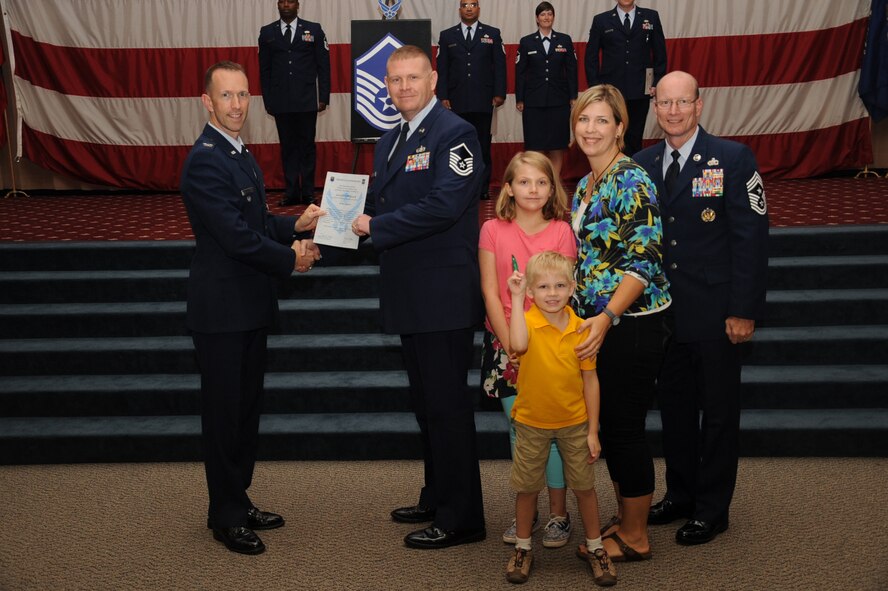 Master Sgt. Daniel Spurlock, 608th Air Communications Squadron, receives a certificate of promotion from Col. Leland Bohannon, 2nd Bomb Wing vice commander, and Chief Master Sgt. Terry West, 8th Air Force command chief, during the September Wing Promotion Ceremony on Barksdale Air Force Base, La., Sept. 30, 2013. (U.S. Air Force photo/Senior Airman Sean Martin)