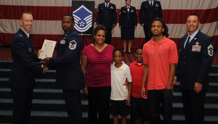 Master Sgt. Daniel Widing, 2nd Maintenance Squadron, receives a certificate of promotion from Col. Leland Bohannon, 2nd Bomb Wing vice commander, and Chief Master Sgt. Curtis Storms, 2nd Bomb Wing command chief, during the September Wing Promotion Ceremony on Barksdale Air Force Base, La., Sept. 30, 2013. (U.S. Air Force photo/Senior Airman Sean Martin)