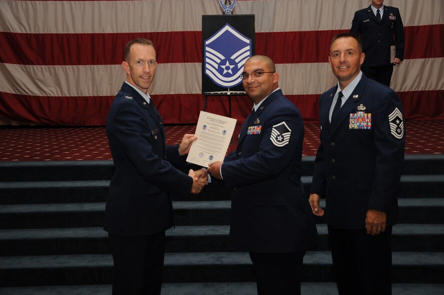 Master Sgt. Jason Foster, 2nd Maintenance Squadron, receives a certificate of promotion from Col. Leland Bohannon, 2nd Bomb Wing vice commander, and Chief Master Sgt. Curtis Storms, 2nd Bomb Wing command chief, during the September Wing Promotion Ceremony on Barksdale Air Force Base, La., Sept. 30, 2013. (U.S. Air Force photo/Senior Airman Sean Martin)