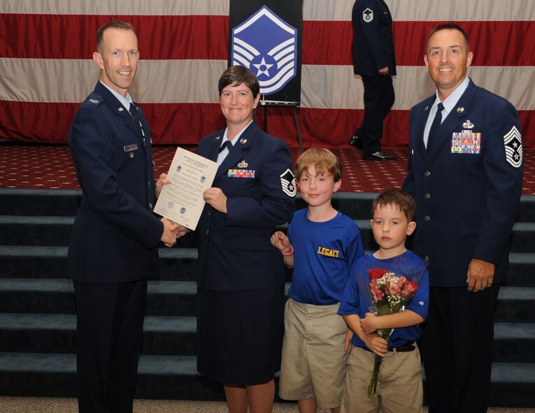 Master Sgt. Jeri Diepering, 2nd Maintenance Squadron, receives a certificate of promotion from Col. Leland Bohannon, 2nd Bomb Wing vice commander, and Chief Master Sgt. Curtis Storms, 2nd Bomb Wing command chief, during the September Wing Promotion Ceremony on Barksdale Air Force Base, La., Sept. 30, 2013. (U.S. Air Force photo/Senior Airman Sean Martin)