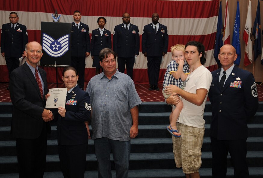Tech. Sgt. Melissa Pederson , Air Force Global Strike Command, receives a certificate of promotion from Jeffrey Beene, AFGSC director of staff, and Chief Master Sgt. Brian Hornback, AFGSC command chief, during the September Wing Promotion Ceremony on Barksdale Air Force Base, La., Sept. 30, 2013. (U.S. Air Force photo/Senior Airman Sean Martin)