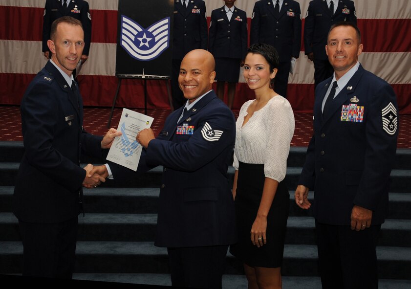 Tech. Sgt.  Damion Washington, 2nd Communications Squadron, receives a certificate of promotion from Col. Leland Bohannon, 2nd Bomb Wing vice commander, and Chief Master Sgt. Curtis Storms, 2nd Bomb Wing command chief, during the September Wing Promotion Ceremony on Barksdale Air Force Base, La., Sept. 30, 2013. (U.S. Air Force photo/Senior Airman Sean Martin)