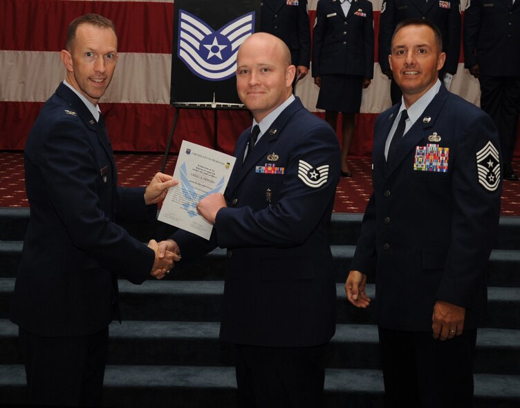 Tech. Sgt.  Craig Howard, 2nd Munitions Squadron, receives a certificate of promotion from Col. Leland Bohannon, 2nd Bomb Wing vice commander, and Chief Master Sgt. Curtis Storms, 2nd Bomb Wing command chief, during the September Wing Promotion Ceremony on Barksdale Air Force Base, La., Sept. 30, 2013. (U.S. Air Force photo/Senior Airman Sean Martin)