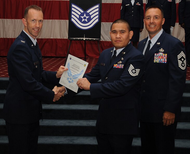 Tech. Sgt.  Steven Gutierrez, 2nd Maintenance Squadron, receives a certificate of promotion from Col. Leland Bohannon, 2nd Bomb Wing vice commander, and Chief Master Sgt. Curtis Storms, 2nd Bomb Wing command chief, during the September Wing Promotion Ceremony on Barksdale Air Force Base, La., Sept. 30, 2013. (U.S. Air Force photo/Senior Airman Sean Martin)