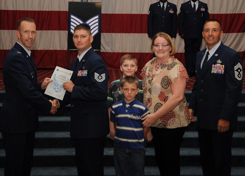 Tech. Sgt.  William Johnson, 2nd Logistics Readiness Squadron, receives a certificate of promotion from Col. Leland Bohannon, 2nd Bomb Wing vice commander, and Chief Master Sgt. Curtis Storms, 2nd Bomb Wing command chief, during the September Wing Promotion Ceremony on Barksdale Air Force Base, La., Sept. 30, 2013. (U.S. Air Force photo/Senior Airman Sean Martin)