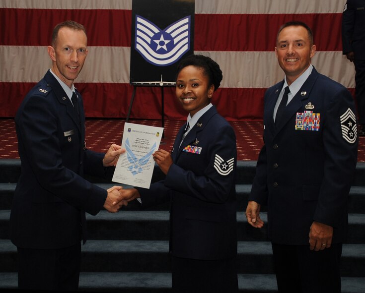 Tech. Sgt.  Jessica Barron, 2nd Force Support Squadron, receives a certificate of promotion from Col. Leland Bohannon, 2nd Bomb Wing vice commander, and Chief Master Sgt. Curtis Storms, 2nd Bomb Wing command chief, during the September Wing Promotion Ceremony on Barksdale Air Force Base, La., Sept. 30, 2013. (U.S. Air Force photo/Senior Airman Sean Martin)