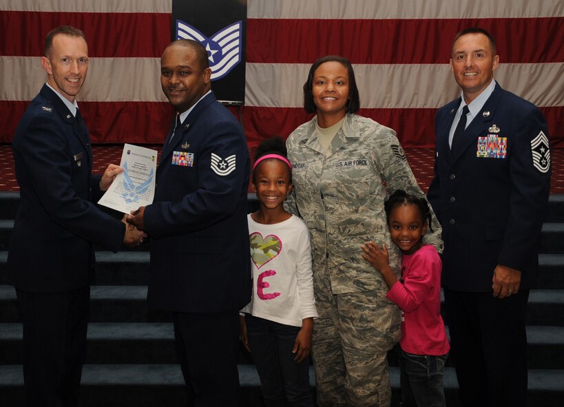 Tech. Sgt. Stepheno Pomerlee, 2nd Communications Squadron, receives a certificate of promotion from Col. Leland Bohannon, 2nd Bomb Wing vice commander, and Chief Master Sgt. Curtis Storms, 2nd Bomb Wing command chief, during the September Wing Promotion Ceremony on Barksdale Air Force Base, La., Sept. 30, 2013. (U.S. Air Force photo/Senior Airman Sean Martin)