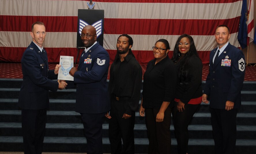 Tech. Sgt. Benjamin Griffin, 2nd Aircraft Maintenance Squadron, receives a certificate of promotion from Col. Leland Bohannon, 2nd Bomb Wing vice commander, and Chief Master Sgt. Curtis Storms, 2nd Bomb Wing command chief, during the September Wing Promotion Ceremony on Barksdale Air Force Base, La., Sept. 30, 2013. (U.S. Air Force photo/Senior Airman Sean Martin)