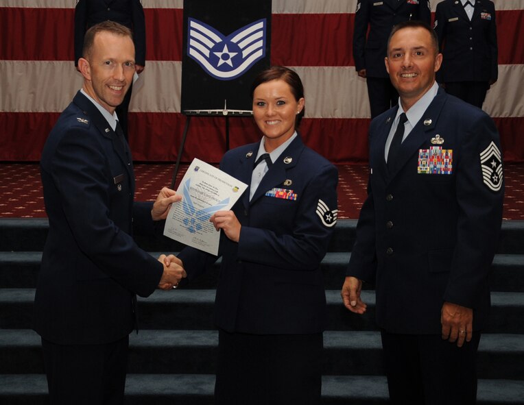 Staff Sgt. Stephanie Wiltrout, 2nd Operation Support Squadron, receives a certificate of promotion from Col. Leland Bohannon, 2nd Bomb Wing vice commander, and Chief Master Sgt. Curtis Storms, 2nd Bomb Wing command chief, during the September Wing Promotion Ceremony on Barksdale Air Force Base, La., Sept. 30, 2013. (U.S. Air Force photo/Senior Airman Sean Martin)